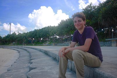 Henry sitting on beach. 