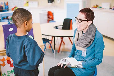 PreK teacher talking to a student