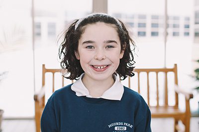 Middle School student in front of bench