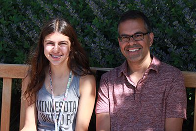 Father and daughter sitting on bench at Mounds Park Academy