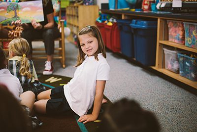 Kindergarten student listening to a story