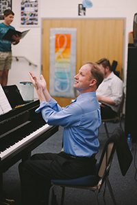 Choir teacher directing students