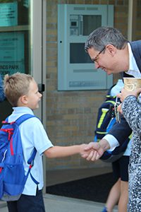 dr. Hudson welcoming students on first day of school