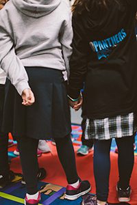 two students holding hands