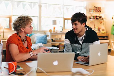 Student talking with teacher