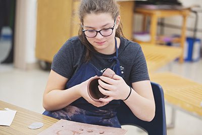 Middle Schooler in ceramics class 