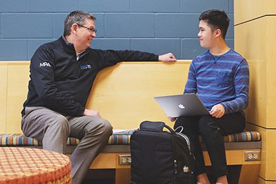 Dr. Hudson in the commons with upper school student