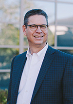 Head of school standing in front of windows