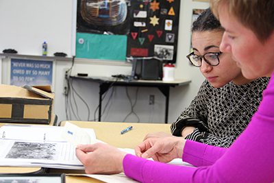 Salmah and Ms. Murr looking at photos