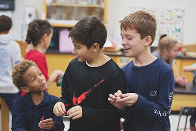 Two fifth graders with kindergartener