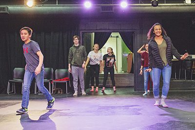 Middle school students dance in drama class