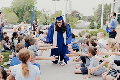 Julia portis '19 gives out high fives in the senior walk
