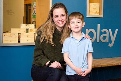 upper school student hugs lower school student outside of the makerspace