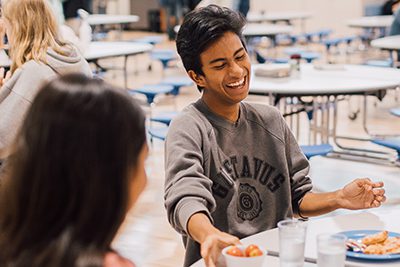 upper school students eating lunch together in the family commons