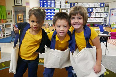 kindergartners with the canvas bags that they made