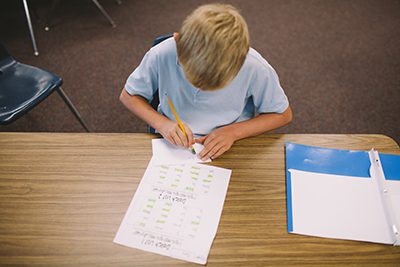 child doing work in the classroom