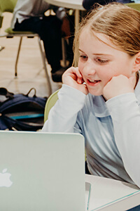 lower school student working on a laptop