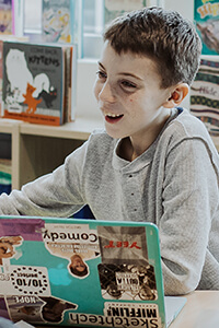 middle school student working at a laptop