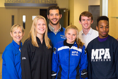 Bev with track runners and track alumni