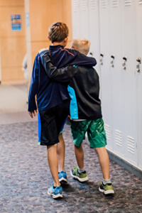 two middle school students walking in the hall together