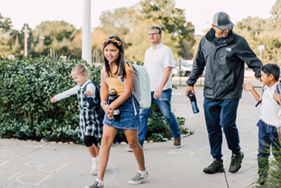 middle and lower school students on campus with parents