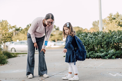 lower school student and parent arriving on campus