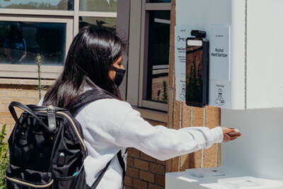 upper school student using the health scan station