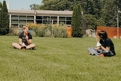 middle school students physically distant playing outside