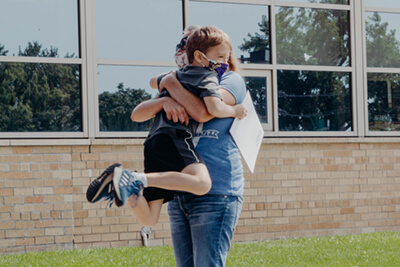 parent hugging their lower school sudent