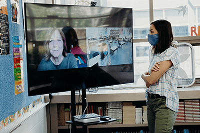 Maddy Wolfe talking to Anne Atchison through a TV