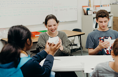 Middle school students doing work together in classroom