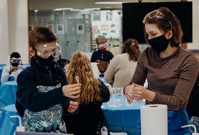 upper school and fourth grade chemistry doing a lab together