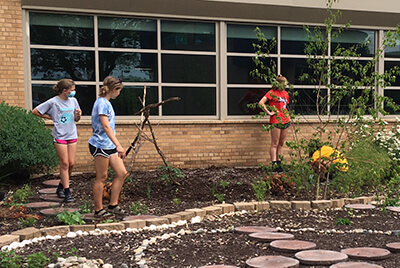 student volunteers working in the garden