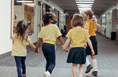 kindergarteners holding hands in the hall