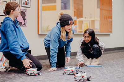 Middle School students collaborating on robotics