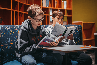 middle school students reading in the library