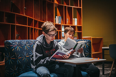 students reading in the cozy library