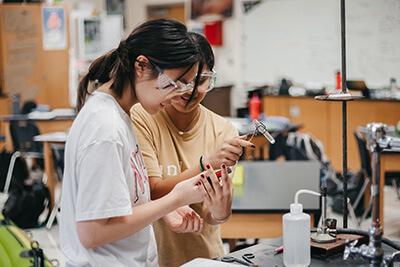 Two students working on science lab together